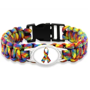 Detail of multi-color paracord bracelet with puzzle ribbon autism awareness charm