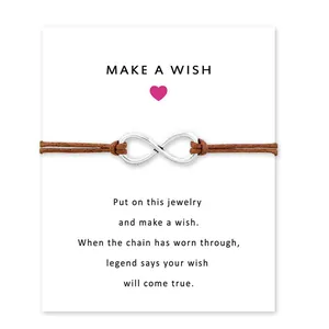 Infinity symbol bracelet with brown wax cord presented on a Make a Wish display card