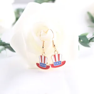 Detailed macro view of USA flag Uncle Sam hat enamel dangle earrings for Independence Day
