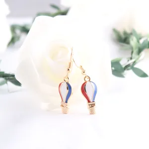 Close-up of hot air balloon earrings with red white and blue enamel USA flag theme