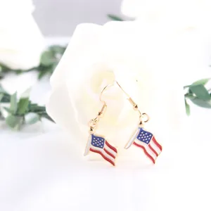 Close-up detail of USA flag drop earrings with enamel finish and gold hooks