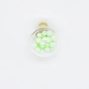 Detail view of 16mm transparent glass globe pendant filled with mint green foam beads.