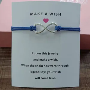 Blue cord infinity symbol bracelet with a printed 'Make a Wish' greeting card.