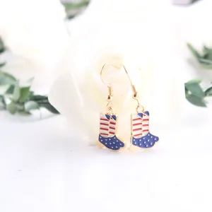 Close-up of patriotic American flag boot earrings with red white and blue enamel detail