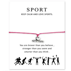 Gros plan du bracelet rose avec breloque I Heart Gymnastics sur carte blanche.