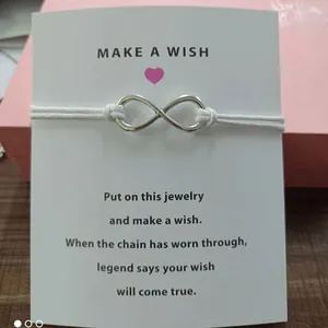 Infinity symbol wish bracelet with white cord and 'Make a Wish' card message