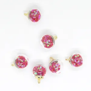 Close-up detail of 16mm glass sphere charms with colorful pink star-shaped sequins inside