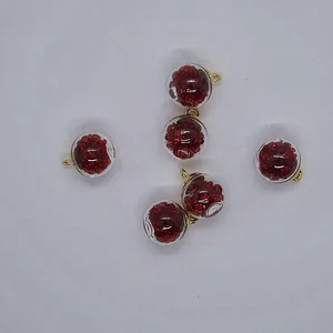 Close-up of 16mm transparent glass ball charms with red glitter for DIY jewelry making