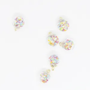 Detailed view of 16mm glass ball charms filled with colorful mini star glitters