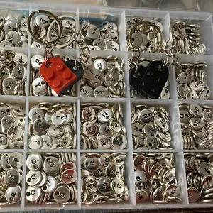 Detailed view of DIY heart building block keychains with A-Z alphabet charms.