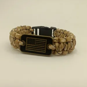 Close-up of paracord bracelet featuring a metal plate with American flag design
