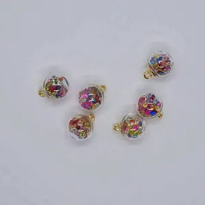 Detailed view of 16mm clear glass ball charms filled with colorful rhinestones for DIY