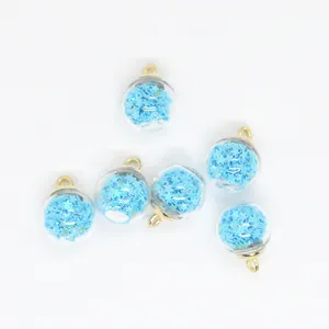 Macro detailed view of 16mm clear glass ball charms filled with tiny light blue stars