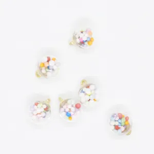 Macro detail of 16mm transparent round charms filled with vibrant multi-colored foam balls.