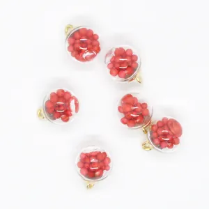 Macro detail view of 16mm clear glass ball charms filled with vibrant red foam beads