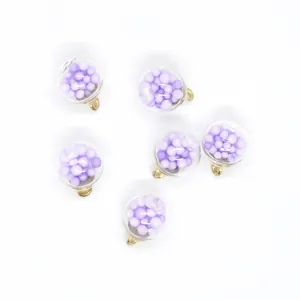 Macro view of 16mm round transparent pendants with purple foam balls for DIY jewelry