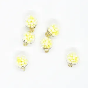 Detail view of 16mm transparent charms filled with yellow foam balls for DIY jewelry