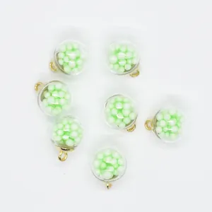 Detailed view of 16mm round transparent charms filled with light green foam balls for DIY.
