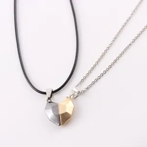 Close-up of magnetic heart-shaped pendant necklace set for couples in gold and silver finish