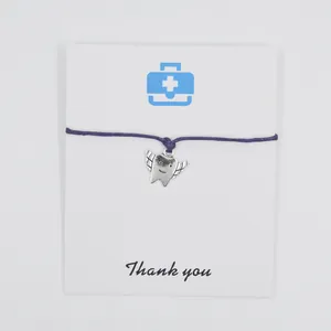 Detailed view of angel tooth charm bracelet on card with Thank you message printed