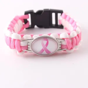 Dettaglio bracciale in paracord rosa e bianco con nastro per la sensibilizzazione