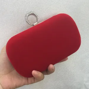 Elegant red velvet evening clutch bag with sparkling rhinestone-encrusted ring-shaped clasp
