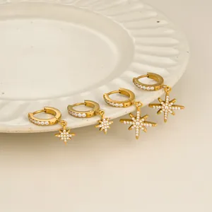 Elegant 18k gold plated stainless steel star hoop earrings on a ceramic plate