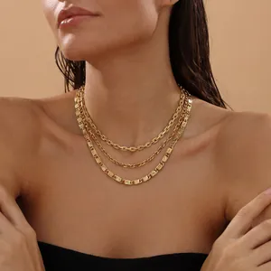 Detail view of vintage triple-layer gold necklace with sunburst texture on a model