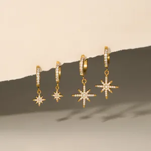 Detailed close-up of gold-plated star hoop earrings with sparkling cubic zirconia inlay