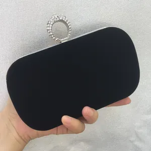 Detailed view of luxury black velvet evening clutch bag with rhinestone ring clasp