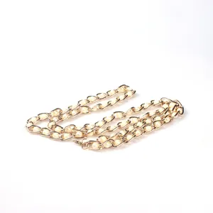 Detailed view of 115cm gold metal bag chain strap featuring woven white pearls and lobster clasp