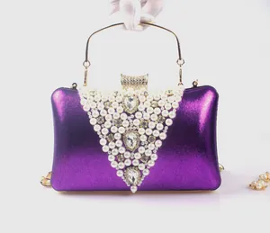 Elegant purple evening clutch bag with V-shaped pearl embroidery and gold top handle