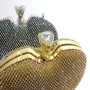 Macro detail of a sparkling gold rhinestone evening clutch with a luxury crystal ring clasp