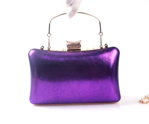 Close-up of purple metallic evening clutch bag with elegant pearl trim details