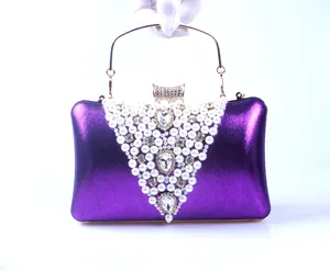 Detailed view of luxury purple evening clutch bag featuring V-shaped pearl hand-beading