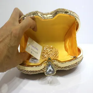 Detailed interior view of a gold rhinestone heart evening clutch with chain strap