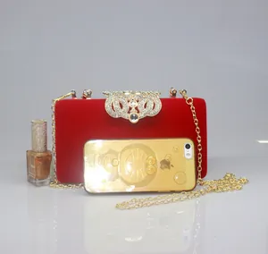 Elegant red velvet evening clutch with crown rhinestone clasp and gold chain strap