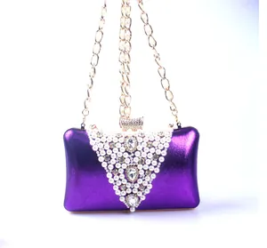 Detailed view of the purple evening clutch with V-shaped pearl and rhinestone embroidery