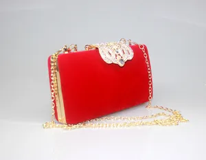 Detailed view of red velvet texture and ornate golden crown rhinestone clasp.
