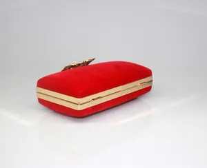 Elegant red velvet evening clutch bag with gold-toned metal frame and crown clasp.