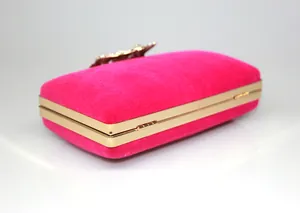 Side view of hot pink velvet evening clutch bag with golden frame and crystal crown