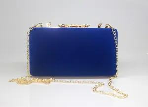 Royal blue velvet clutch bag with gold crown rhinestone clasp and chain strap for weddings.