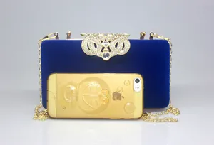 Elegant blue velvet evening clutch bag featuring rhinestone crown clasp and chain