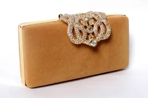 Elegant velvet clutch bag with a large rhinestone crown ornament for bridal dinners.
