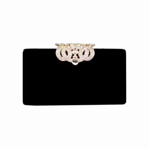 Elegant black velvet evening clutch bag with sparkling rhinestone crown clasp