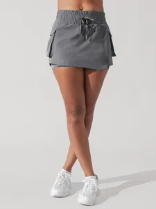 Detailed view of gray athletic cargo skort featuring drawstring waist and side pockets
