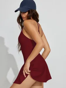 Side view of a dark red backless tennis dress with cross straps for a stylish sporty look