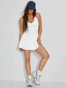 Detailed view of a white ribbed mini tennis dress with sexy open back cross straps