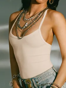Detailed view of a sexy beige ribbed backless tank top with layered necklace styling