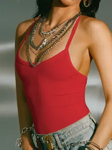Detailed shot of a red ribbed backless camisole styled with edgy chunky silver jewelry